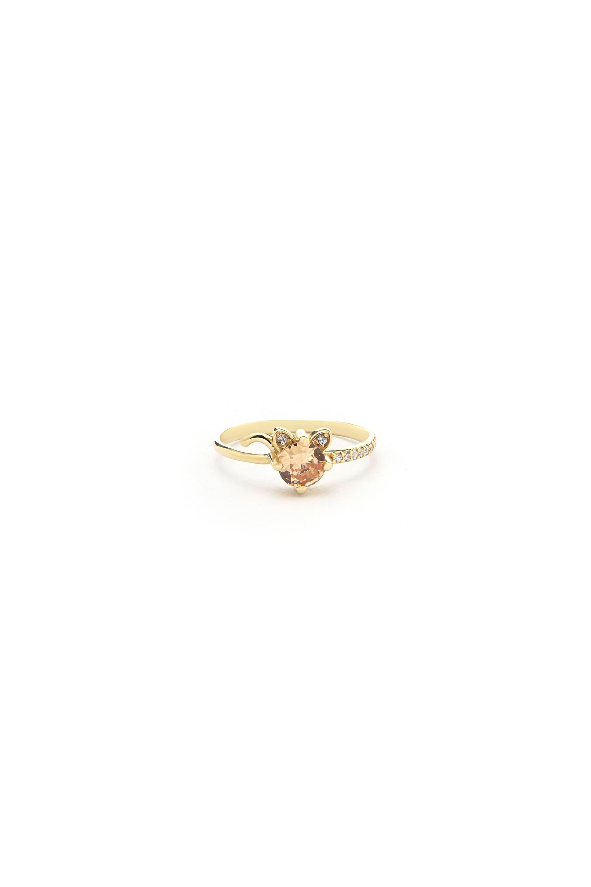 A gold ring with a heart-shaped gemstone set in the center.