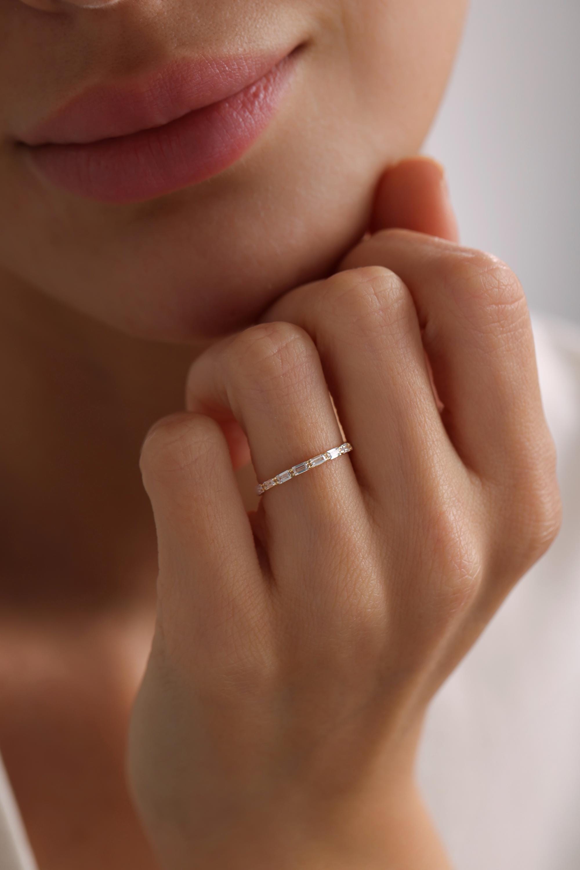 May include: A thin gold band ring with small diamonds set in a pave setting.