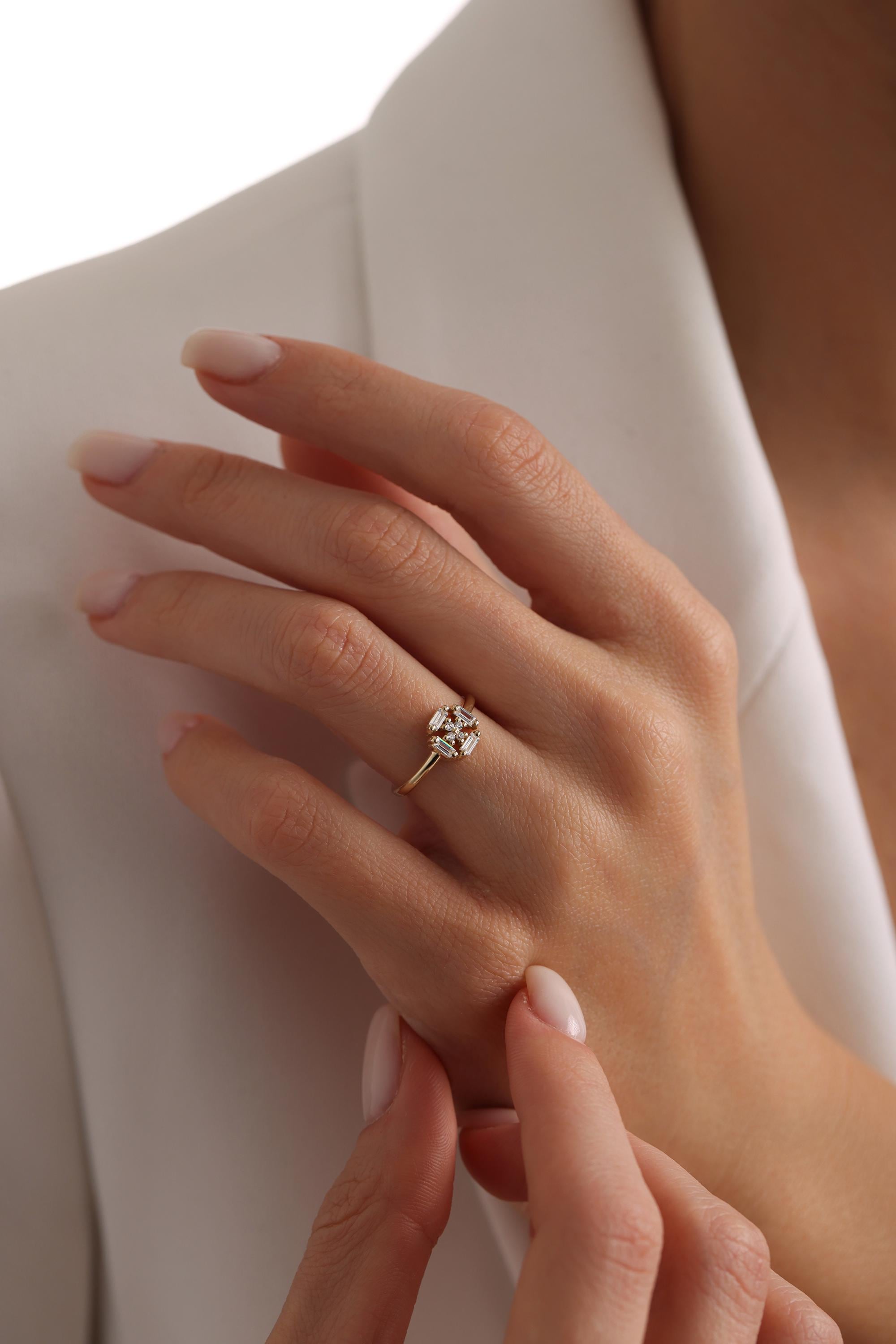 A close-up of a person's hand wearing a gold ring with a small diamond.