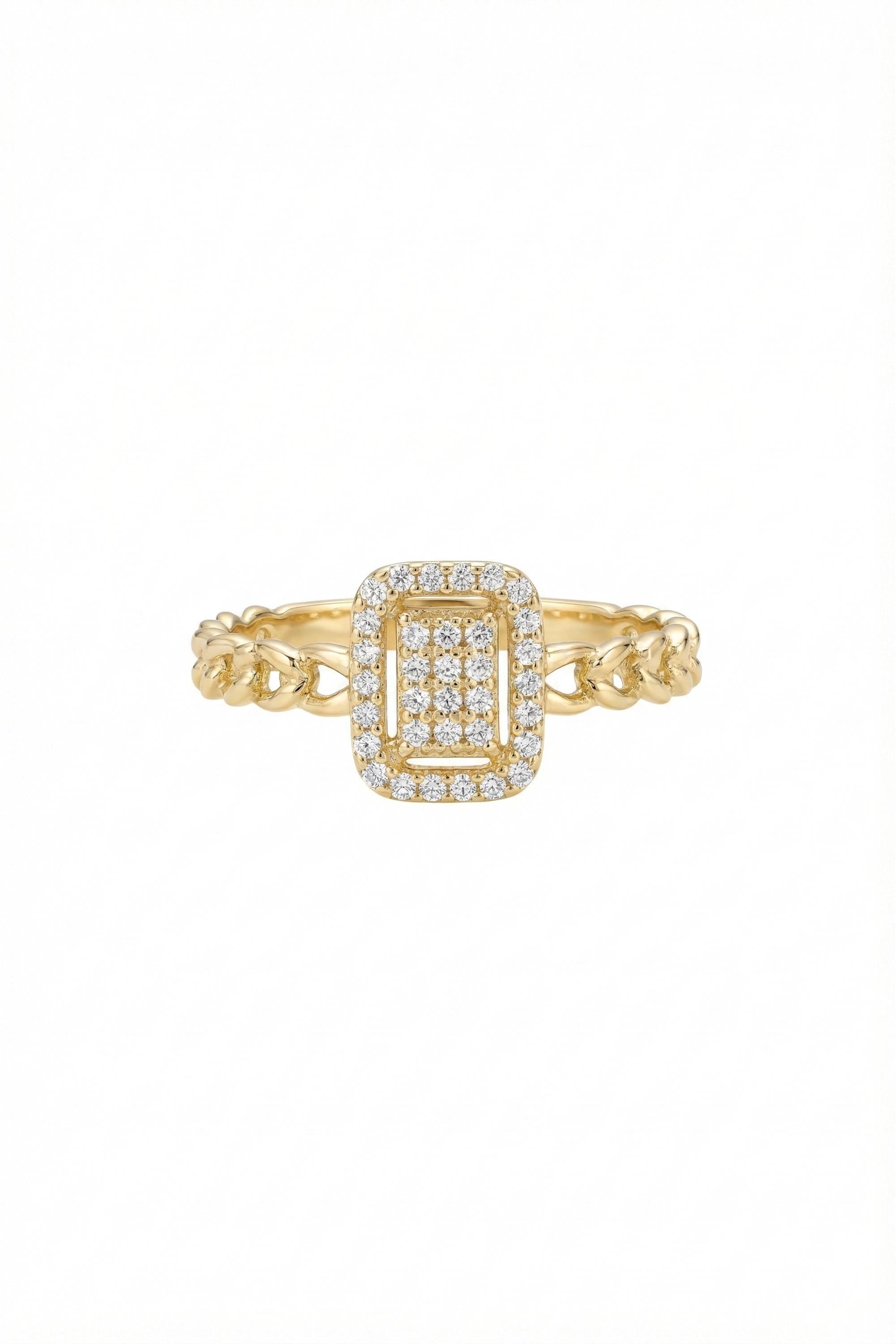 May include: A gold ring with a rectangular center stone, surrounded by a halo of small, clear stones. The band features a chain-link design. The ring is set against a white background.